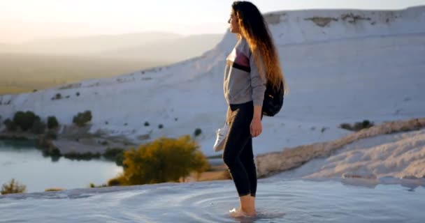 Young woman walking in Pamukkale terraces — Stockvideo