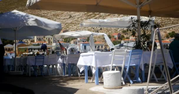 Wooden table and chairs prepared for clients by the sea coast — Stockvideo