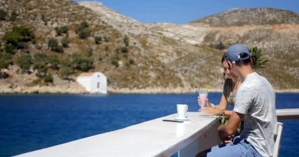 Young couple drinking coffee and milkshake outdoors — 비디오