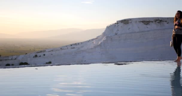 Young woman walking in Pamukkale terraces — Stockvideo