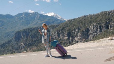 Dışarıda cep telefonuyla ağ kurmaya çalışan genç bir kadın.