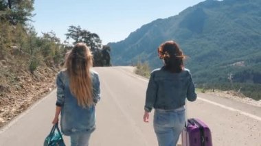 İki genç kız güzel doğa manzara ile yolda yürüyor