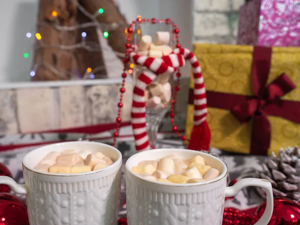 hot chocolate with small marshmallows on the blanket