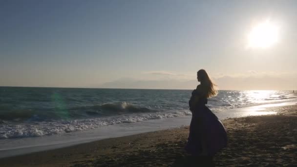 Young woman in dress walking alone by the sea — Stock Video