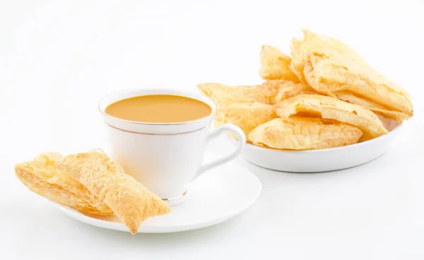 Indian Tea Time Breakfast Khari Also Know as Kharee, Khari Biscuit or Salty Puff Pastry Snacks, Served with Indian Hot Masala Chai or Hot Tea Isolated on White Background