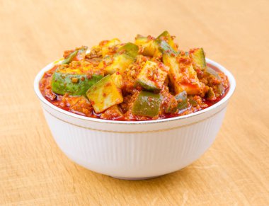Indian Traditional Raw Mango Pickle Also Know as Aam Ka Achar or Kari Ka Achar on Wooden Background clipart