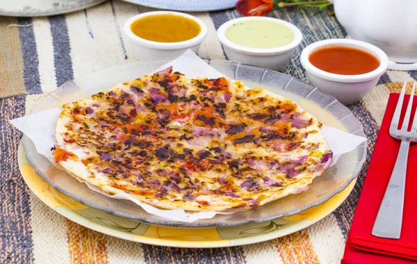 South Indian Food Uttapam Also Know As ooththappam, Rava Uttapam, Uttapa or Uthappa is a Popular South Indian Delicious Spicy Breakfast Snack Served with Coconut Chutney, Tomato Sauce and Sambar