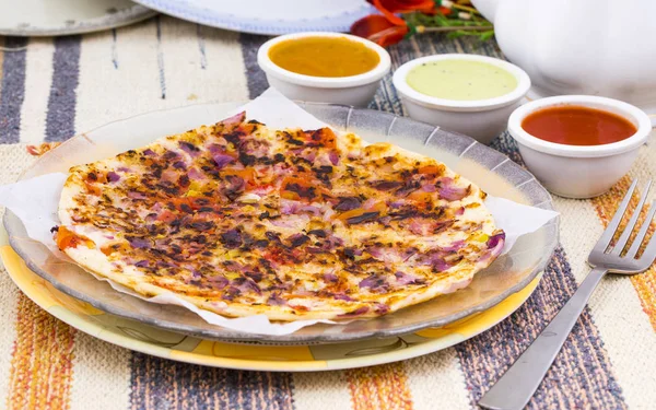 South Indian Food Uttapam Also Know As ooththappam, Rava Uttapam, Uttapa or Uthappa is a Popular South Indian Delicious Spicy Breakfast Snack Served with Coconut Chutney, Tomato Sauce and Sambar