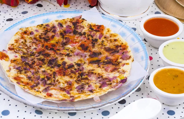 South Indian Food Uttapam Also Know As ooththappam, Rava Uttapam, Uttapa or Uthappa is a Popular South Indian Delicious Spicy Breakfast Snack Served with Coconut Chutney, Tomato Sauce and Sambar