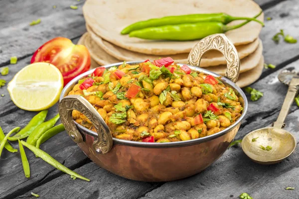 Indian Cuisine Rajma Masala or Rajmah is a South Asian Vegetarian Dish Consisting of White Kidney Beans in a thick gravy with many Indian whole spices and usually served with Chapati and food