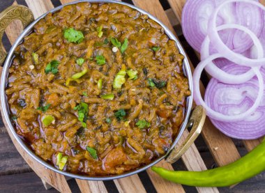 Hint mutfağı Sev Tamaeta ya da Sev Tameta da Chapati, Papad, Onion ya da Raita ile servis edilir. Domatesli ve soğan soslu, ahşap masa üzerinde baharatlı Sev soslu.