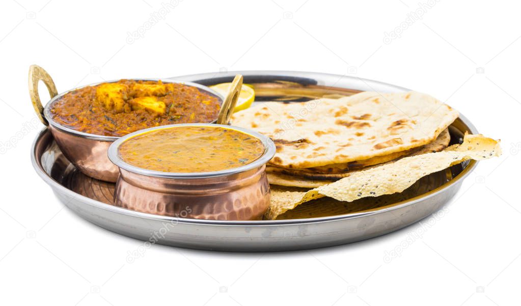 Indian Traditional Thali Food Dal Makhani Served with Chapati, Papad, Kadai Paneer or Lemon Also Know as Dal Makhni or Daal Makhani is a Popular Dish From Punjab. isolated on White Background
