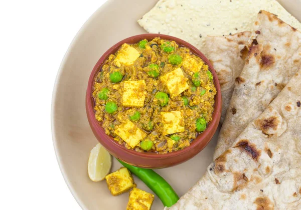 Indian Cuisine Mattar Paneer is a Vegetarian North Indian Dish Consisting of Peas And Paneer in a Tomato Based Sauce, Spiced with Garam Masala. It is often Served with Indian type of Tandoori Roti