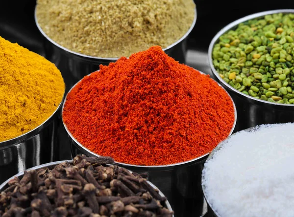 Indian Colorful Spices Also Know as Red Chilli Powder, Turmeric Powder, Coriander Powder, Cloves, Salt, Green Fenugreek Seeds, Namak, Mirchi, Haldi, Dhaniya Powder or Lavang.