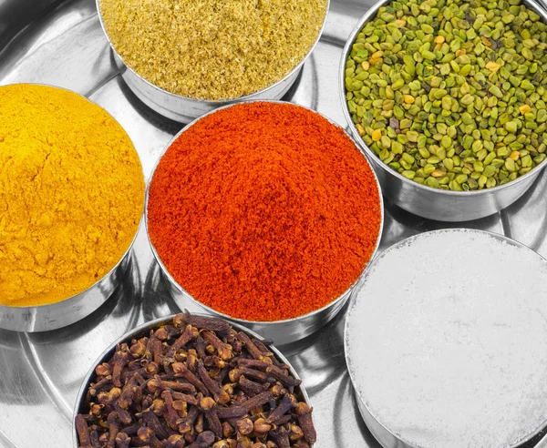 Indian Colorful Spices Also Know as Red Chilli Powder, Turmeric Powder, Coriander Powder, Cloves, Salt, Green Fenugreek Seeds, Namak, Mirchi, Haldi, Dhaniya Powder or Lavang.