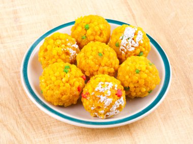 Laddu also know as laddoo, ladoo, laddo are ball-shaped sweets popular in the Indian festivals. Laddu are made of flour, minced dough and sugar with other ingredients. clipart