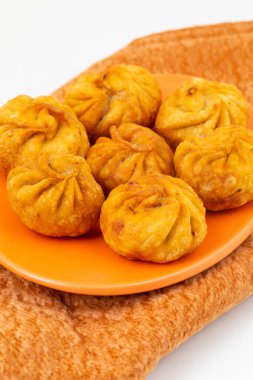 Kızarmış Momos, Nepal 'den geleneksel bir hamur yemeğidir. Schezwan Sosu ve Krema ile servis edilir.