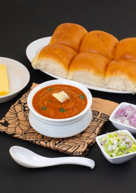 Pav Bhaji bir Hint Geleneksel Popüler Sokak Fast Food 'udur. Kalın ve baharatlı baharatlı köri yanında yumuşak ekmek rulosu ve tereyağlı çörek.