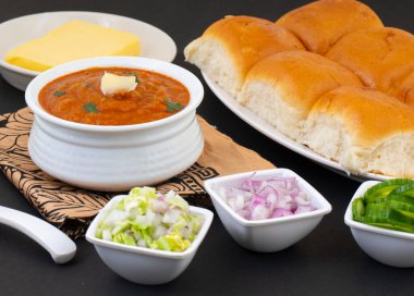 Pav Bhaji is a Indian Traditional Popular Street Fast Food. Thick And Spicy Vegetable Curry Served With a Soft Bread Roll/Bun Paav And Butter clipart