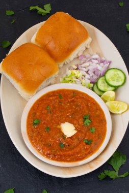 Pav Bhaji is a Indian Traditional Popular Street Fast Food. Thick And Spicy Vegetable Curry Served With a Soft Bread Roll/Bun Paav And Butter clipart