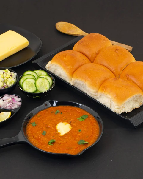 Pav Bhaji bir Hint Geleneksel Popüler Sokak Fast Food 'udur. Kalın ve baharatlı baharatlı köri yanında yumuşak ekmek rulosu ve tereyağlı çörek.