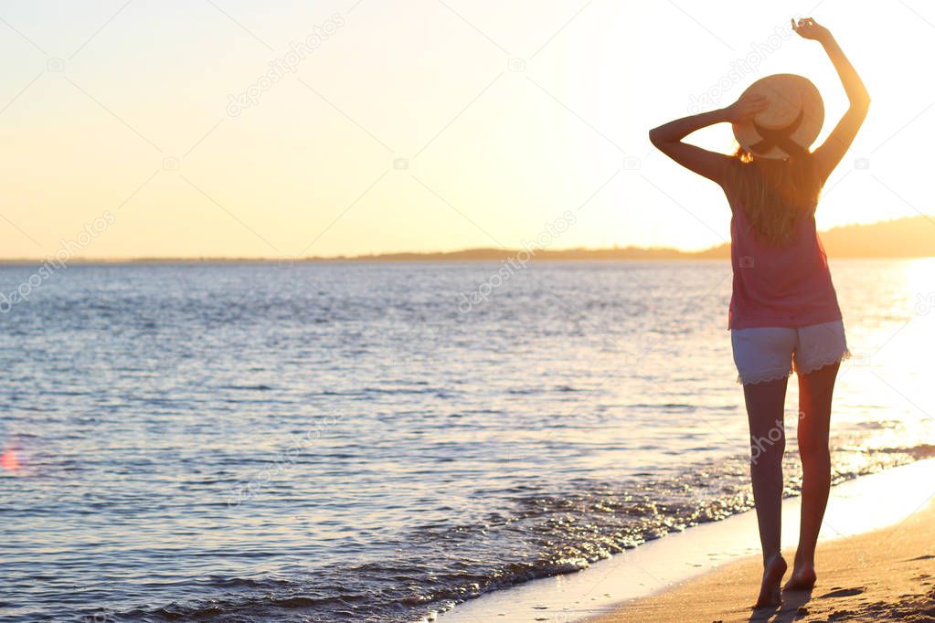 the girl is walking on the beach