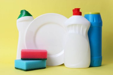 bulaşık sıvısı, süngerler, renkli arka planda plaka. ev işleri, Yıkama yemekleri