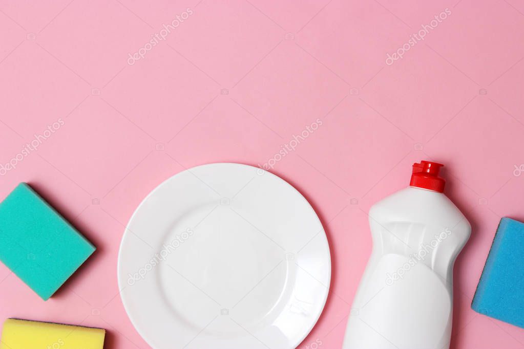 dish washing, sponges, plate on a colored background top view with place for inserting text. household chores, washing dishes. flatlay
