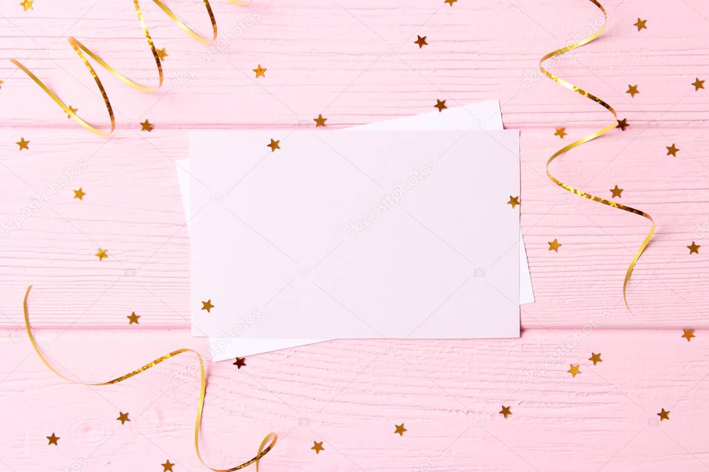 sparkles confetti and card for inserting text on a colored background top view. Minimalism, design,  holiday.flatlay