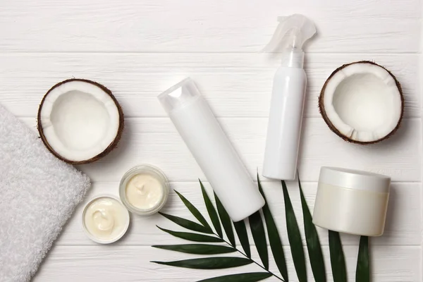 tropical leaf, cosmetic care products and coconut. Hair, skin or body products.Flatlay