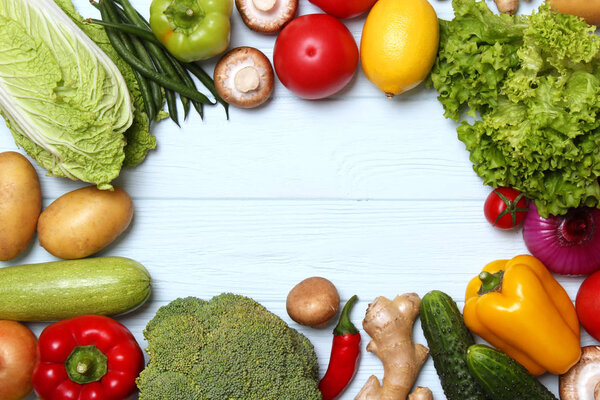 Different fresh vegetables on a wooden table top view. Proper and healthy food, diet, vegetarian. Cooking food, vegetable dishes. flat lay