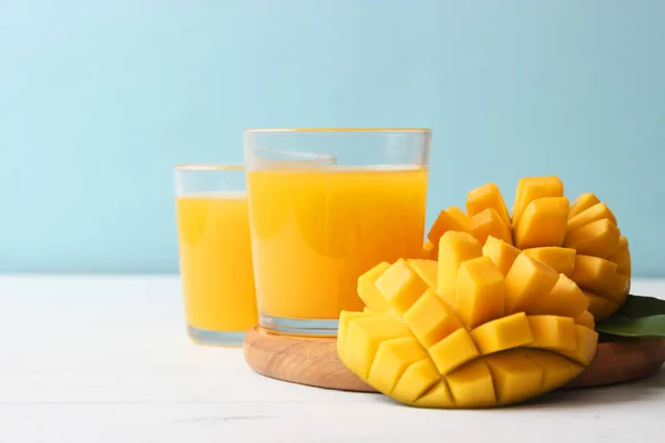 mango juice in a glass and mango fruit.