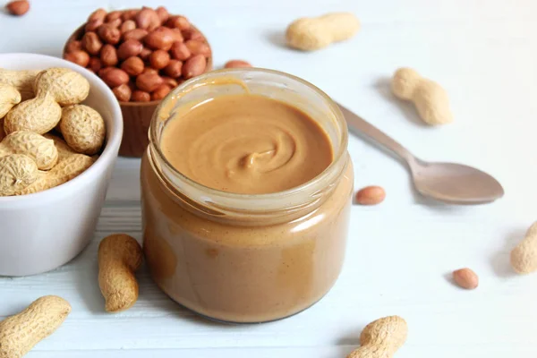 peanut butter and peanut beans on wooden background