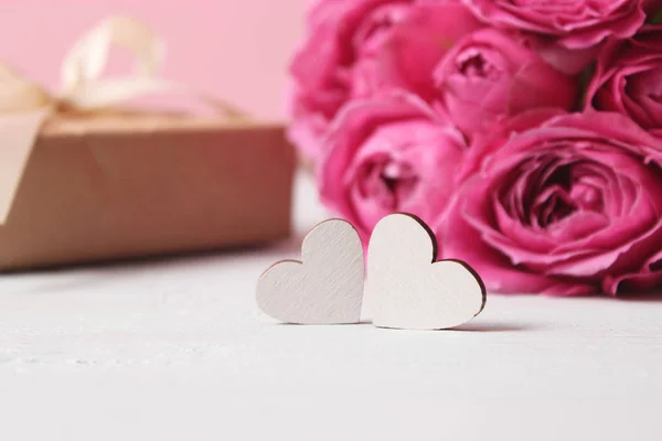 hearts on blurred background of flowers. Background to the day of Saint Valentine.