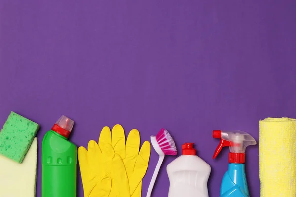 cleaning products on a colored background top view.