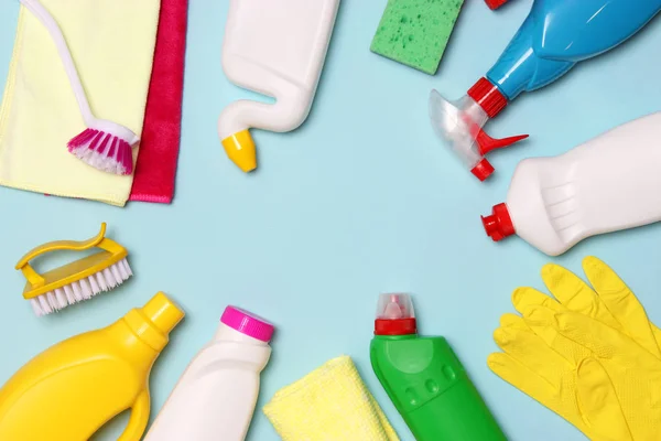 cleaning products on a colored background top view.