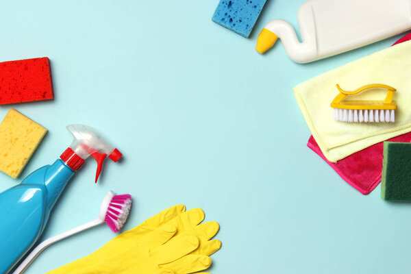 cleaning products on a colored background top view.