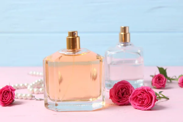 perfume and flowers on a colored background.