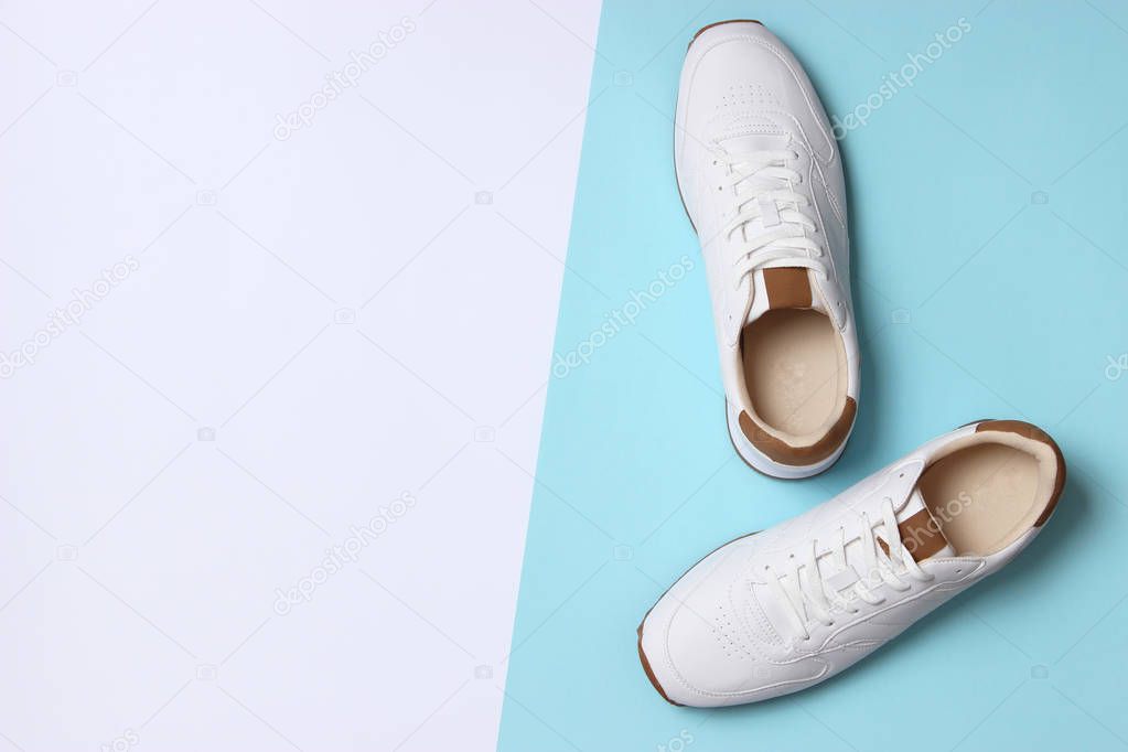 men's sneakers on a colored background top view. men's footwear. minimalism