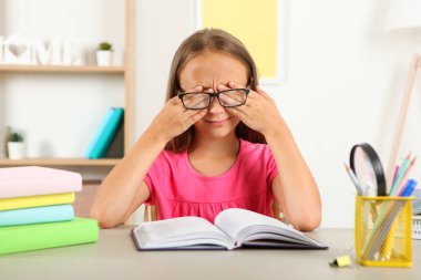 Küçük kızın gözlüğü yüzünden gözleri acıyor. Çocuklarda görme sorunları, görme düzeltmesi ve muayene.