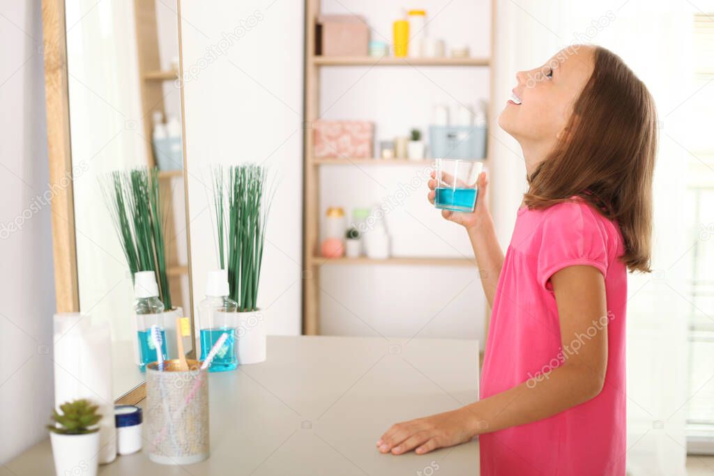 the child is rinsing the mouth with a mouthwash. Oral health in children, prevention of dental diseases