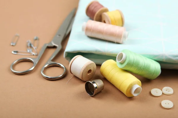 Composition with threads and sewing accessories - scissors, centimeter,  pins on yellow background. Stock Photo by ©nuclear_lily 236814992