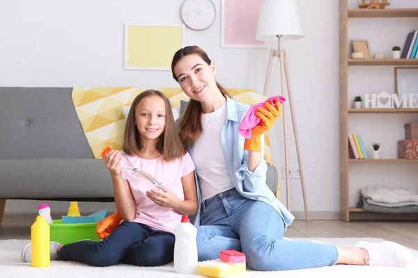 stock image Mother and daughter in a good mood are cleaning the house with disinfectants and detergents