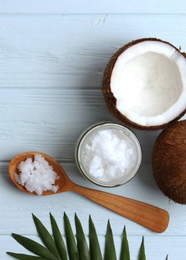 coconut oil and coconuts, palm branches close up. High quality photo. Vertical photo format