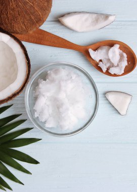 coconut oil and coconuts, palm branches close up. High quality photo. Vertical photo format