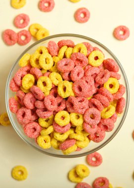 colored corn rings for breakfast on the table close-up. High quality photo. Vertical photo format