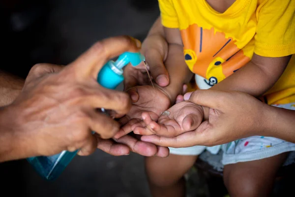 A child is learning how to clean hands with liquid cleaning gel. To prevent coronavirus, rubbing your hands with soap is an expert way to stop the spread of coronavirus.