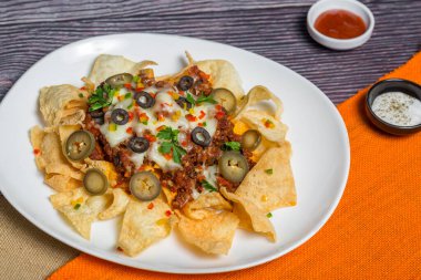 Meksika Meşhur Yemekleri Baharatlı Baharatlı Biftek Nachos. Eritilmiş peynirli ve jalapenolu kızarmış tortilla cipsleri abur cubur servisi yapar..