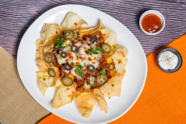 Meksika Meşhur Yemekleri Baharatlı Baharatlı Biftek Nachos. Eritilmiş peynirli ve jalapenolu kızarmış tortilla cipsleri abur cubur servisi yapar..