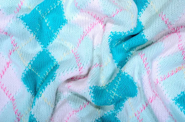 合上皱巴巴的针织羊毛织物质地 蓝色菱形编织毛衣作为背景 — 图库照片